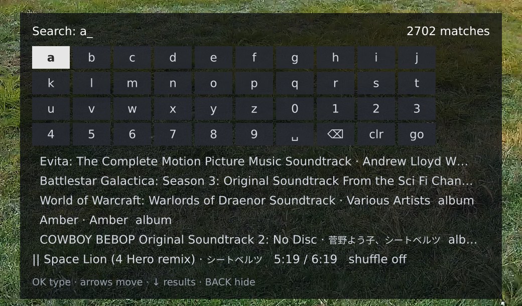 The search panel: the query a with 2702 matches on the right, a four-row on-screen keyboard with a focused, and five result rows of albums including one with a Japanese artist name, over the now-playing strip